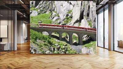 alpine express passing bridge at st. gotthard pass in switzerlan Wall mural