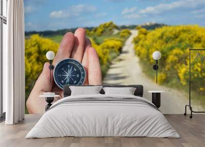 compass in the hand against rural road Wall mural