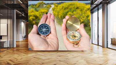 Two compasses in the hands Wall mural