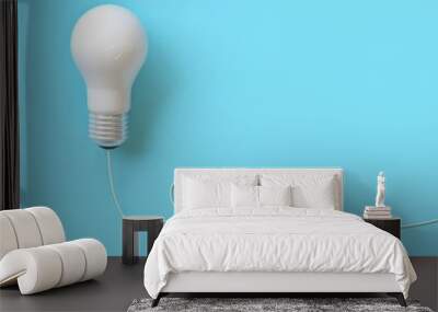 white lightbulb with wire on blue background for copyspace. minimal idea concept. top view Wall mural