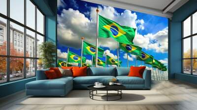 Vibrant green and yellow flags of Brazil wave proudly in the wind, symbolizing national pride and unity, set against a bright blue sky with fluffy clouds. Wall mural