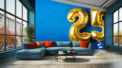 Banner with number 25 golden balloon with copy space. 25 years anniversary celebration. Blue background. Wall mural