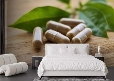 Organic herbal medicine capsule on wooden table with green leaves. Immunity support product. Wall mural