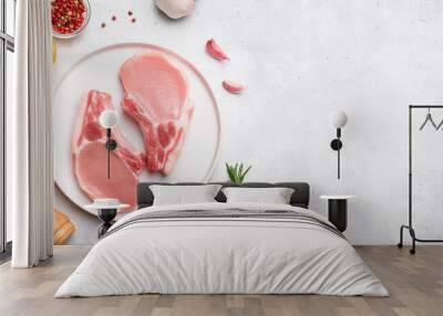 Raw pork chops on white plate with spice. Tasty meat. Cooking and culinary concept. Top view Wall mural