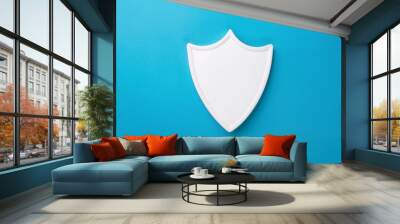 White shield against blue background. Minimalist design. Security and protection concept. Wall mural