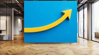 Yellow wooden arrow pointing upwards on blue background. Business and market growth concept Wall mural