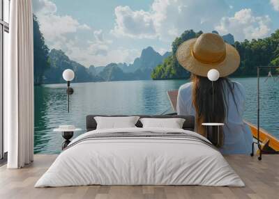 
Travel summer vacation concept, Happy solo traveler asian woman with hat relaxing and sightseeing on Thai longtail boat in beautiful Ratchaprapha Dam at Khao Sok National Park, Surat Thani Province,  Wall mural