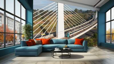 A Sydney metro train crosses a bridge over Windsor Road, Rouse Hill, NSW, Australia Wall mural