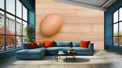 single egg on wooden table, view from top, space for text Wall mural