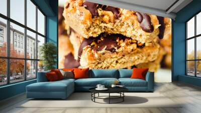 Granola bar cake with date caramel and chocolate. Healthy sweet dessert snack. Cereal granola bar with nuts, fruit and berries on a white marble table. Close-up. Wall mural