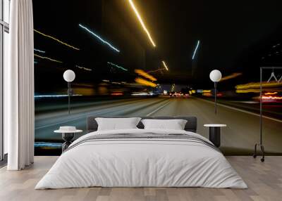 Lights blur along the freeway in a long exposure while driving Wall mural