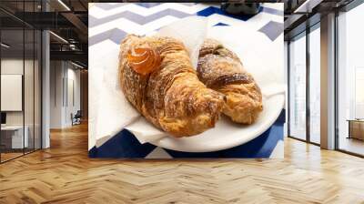 Two croissants sit on a plate Wall mural