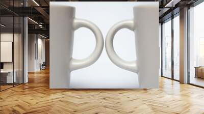 Two ceramic white espresso cups facing each other symmetrical blurred background. Coffee cafe art concept two pair Wall mural