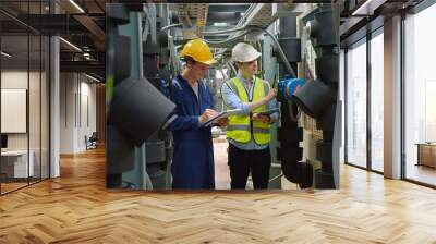 Civil engineer manager and foreman worker checking industry cooling air conditioner water cooling tower air chiller of large industrial building to control air system at construction site Wall mural