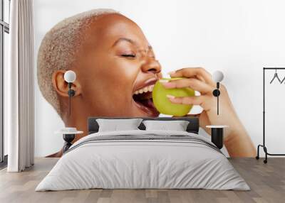 Woman, eating and apple for health, nutrition or wellness in organic diet. African person, eyes closed and fruit in mouth on isolated or transparent png background for wellbeing, vitamin or fibre Wall mural