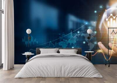 Businessman holding creative light bulb with growth graph, analytics icons. Utilizing analytics technology to develop new strategies and insights that enhance successful performance in global business Wall mural