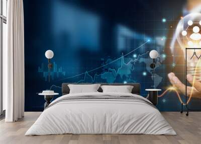 Businessman holding creative light bulb with growth graph, network icons. Leveraging innovation technology to develop new networks and solutions that enhance successful and profit in global business. Wall mural