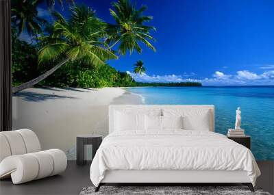 serene white sandy beach with crystal clear blue water and palm trees Wall mural