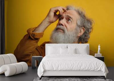 Elder man with beard and grey hair thinking, holding one hand on head  over yellow background, Generative AI Wall mural