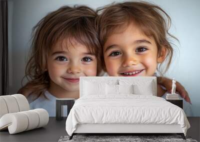 Two young children with brown hair hugging and smiling, wearing white shirts, isolated on white background. Childhood, siblings and friendship, Generative AI Wall mural