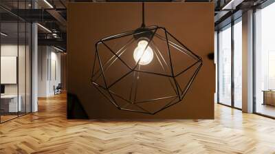 Exotic trigonal lamp lights in the darkness with golden light effects and romantic vintage moments Wall mural