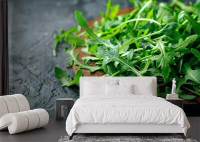 Arugula or rucola leaves on wooden plate, healthy green salad. Generative AI Wall mural