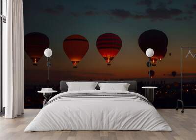 Vivid hot air ballons in the dark night sky. Wall mural