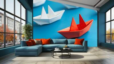 Group of white paper ship in one direction and one red paper ship pointing in different way. Be Creative Concept. Wall mural