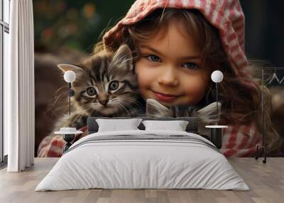 A little girl hugging two kittens in her arms stock photo Wall mural