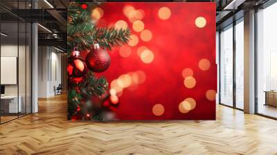 Festive christmas tree decorated with ornaments and glowing bokeh lights on a vibrant red background Wall mural