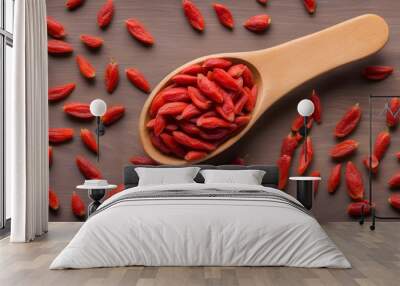 Top view of wooden spoon full of goji berries Wall mural