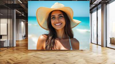 Smiling woman in hat near the beach with bright sea in background. Wall mural