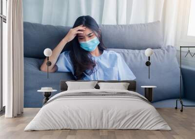 Asian woman patient wearing medical face mask with illness disease sickness unhealthy mind resting hospital, panic patient in medical health care insurance, feeling loneliness sad depression unhappy Wall mural