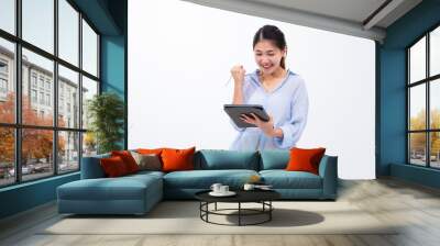 Beautiful Asian woman using pen and tablet portable device computer technology, having fun happy smiling cheering, internet connectivity and digital creative design tool. Wall mural