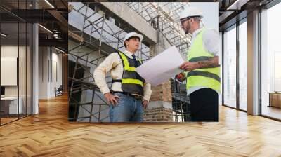 Contractor and engineer architect working together planning using blueprint design structure construction industry, building house innovation and teamwork discussing, two male caucasian collaborating. Wall mural