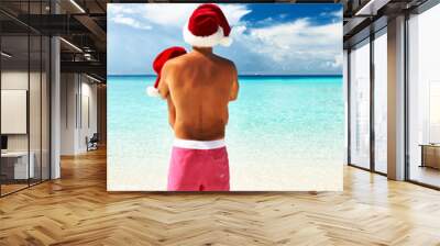 Couple in santa's hat on a beach at Maldives Wall mural