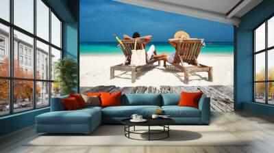 Couple in white relax on a beach at Maldives Wall mural