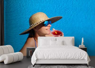 woman at poolside with cosmopolitan cocktail Wall mural