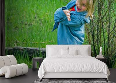 Little girl walking and merely loosing balance, spring background Wall mural