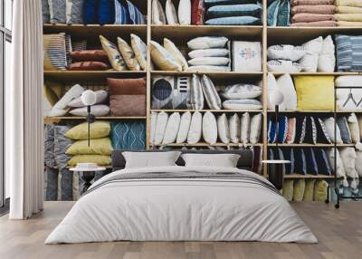 Shelves filled with colorful pillows creating an interesting pattern of shape and tone Wall mural