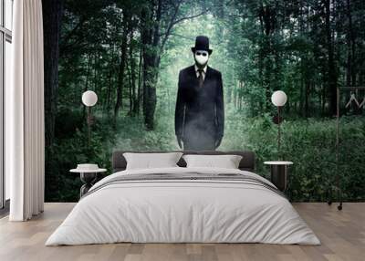 evil tall man standing in scary woods alone Wall mural