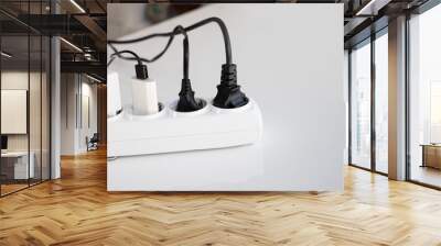 Electric white portable socket with connected devices on white table Wall mural