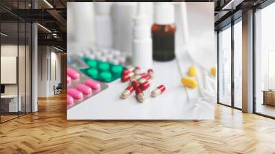 Heap of medical pills in white, red and other colors. Pills in plastic package with mask. Concept of healthcare and medicine. Wall mural