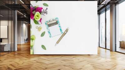 Note pad flat lay with flowers pen white background space for text Wall mural