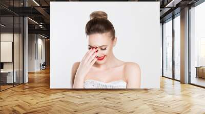 Beautiful woman smiling hand on face isolated white grey wall background. Happiness concept. Horizontal image. Red lips and nails, full makeup beautiful happy woman Wall mural