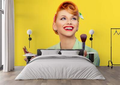 Make up artist. Pin up style holding make up tools Wall mural