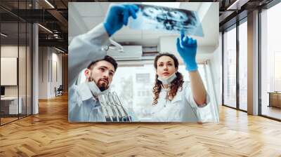 Healthcare, medical and radiology concept - two dentist doctors looking at x-ray. selective focus. Wall mural