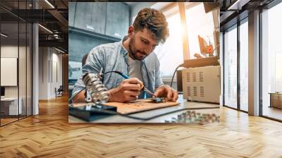 Portrait of a man repairing microcircuits.Concept of engineering, chip development and service. Wall mural