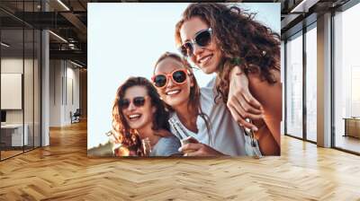 Shot of group of friends cheering with beer on nature Wall mural