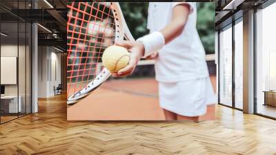 Sporty little girl preparing to serve tennis ball Wall mural